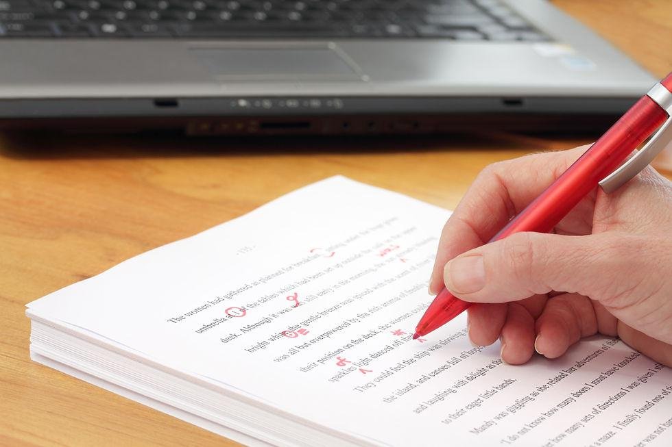A red pen correcting a printed demand letter